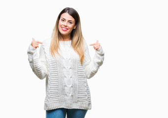 Young beautiful woman casual white sweater over isolated background looking confident with smile on face, pointing oneself with fingers proud and happy.