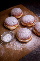 Fresh baked and garnished with powdered sugar german doughnuts
