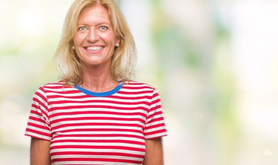 Fototapeta premium Middle age blonde woman over isolated background with a happy and cool smile on face. Lucky person.
