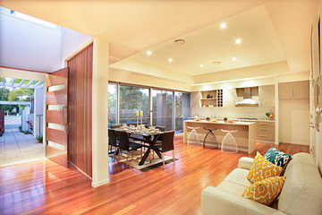 Colorful kitchen with facilities and wooden floor.