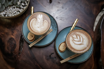 A cup of coffee or cappuccino on a dark wooden table