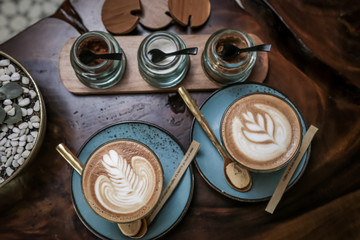 A cup of coffee or cappuccino on a dark wooden table
