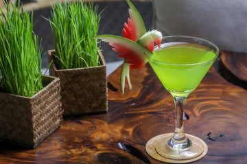 Green cocktail in martini glass with watermelon