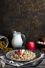 Buckwheat porridge with milk, apple, raisins and cashew nuts