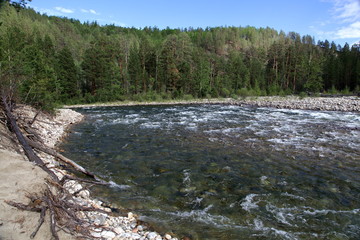 Fototapeta na wymiar Siberian river Barguzin in the upper summer day in one of its turns between the slopes of the mountains