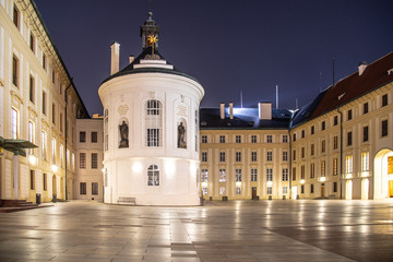 Fototapeta na wymiar Medieval houses and old drinking fountain in Golden Lane by night, Prague Castle, Czech Republic