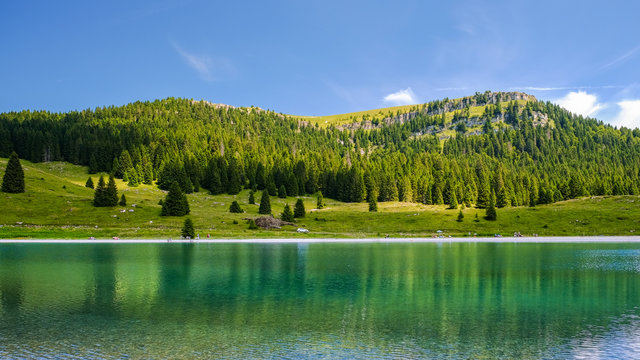 Panorama, landscape of a  turquoise lake in Italy. Passo Coe Lake, Folgaria, Trento, Trentino, Italy - August 2018