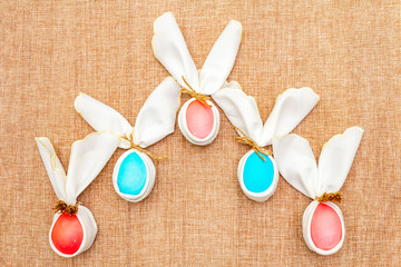 Easter bunny (rabbit) egg concept, table arrangement decoration. Pink (rosy) and blue eggs with...