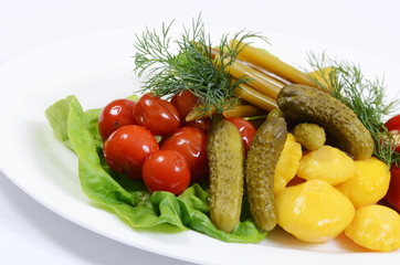 Different types of pickled vegetables on white plate