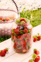 Juicy strawberries in baskeglass jar t in garden, summer in village, farm, harvesting berries.