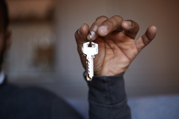 African black man holding home keys in hand.