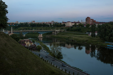 Fototapeta na wymiar Grodno. Belarus. Evening landscape with the river Neman, the embankment of the river and the bridge on the background of a beautiful sky.