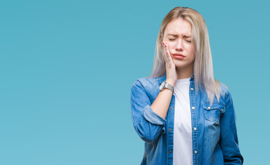 Young blonde woman over isolated background touching mouth with hand with painful expression...