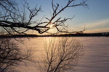 sunset over the frozen river