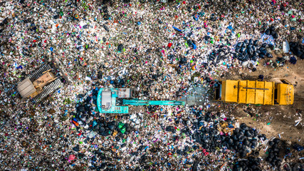 Garbage pile  in trash dump or landfill abundance, Aerial view garbage truck unload garbage to a landfill,  Biohazard global warming ecosystem and healthy environment concept. - obrazy, fototapety, plakaty