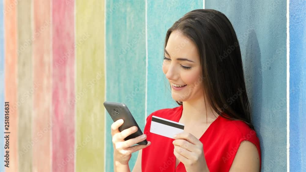 Poster happy woman paying online in a colorful wall