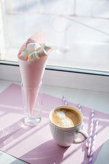 cup of americano coffee on windowsill in sun ray part of a morning routine, minimal concept