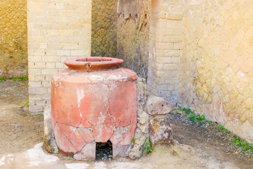 Herculaneum, ancient Roman town. Big wine amphora in warehouse, Ercolano, Italy