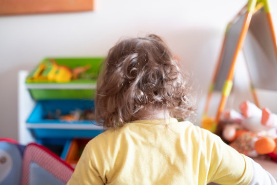 baby girl backwards in a games room