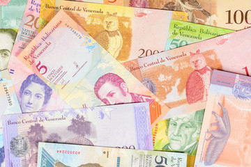 Venezuela bolivar banknotes, different bills of fuerte and soberano series. Beautiful colorful obverse side bolivares close up background.