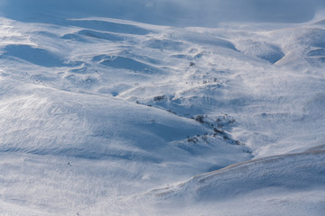 Fototapeta na wymiar Snow covered alpine meadows in winter Lago-Naki, The Main Caucasian Ridge, Russia