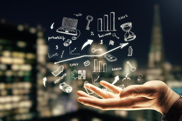 businessman holdin a business concept. Trading graph on the cityscape at background. Double exposure.