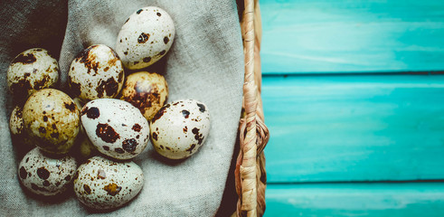 Easter composition with  quail eggs on color wooden background Space for text