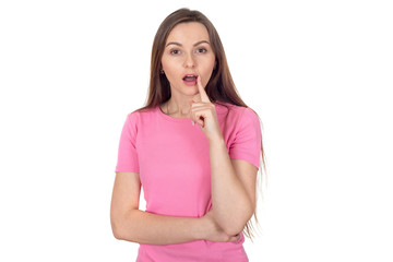 Young woman holds a finger near the lips showing a sign of silence. Shh!  Portrait of a brunette woman with long hair on a white background.