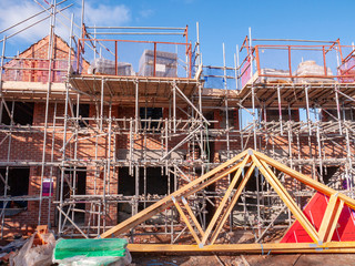 New homes in scaffolding on a new housing estate in Cheshire England UK