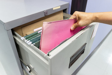 Close up Hand of Man Search files document in a file cabinet in work office, concept business...