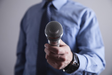 Businessman holding microphone.