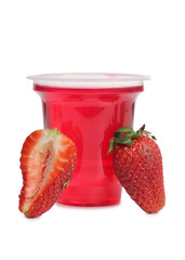 Jam in cup with red strawberries on white background