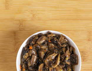 Fried mushrooms in a plate on the table.