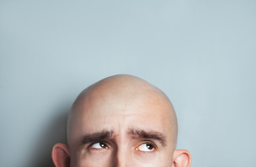 Emotional portrait of surprised bald man. half-face. Copyspace for text. - obrazy, fototapety, plakaty