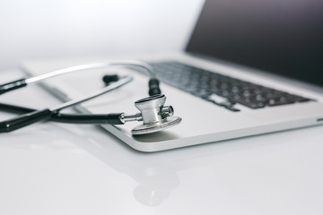 closeup view of stethoscope on laptop keyboard