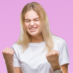 Young caucasian woman over isolated background very happy and excited doing winner gesture with arms raised, smiling and screaming for success. Celebration concept.