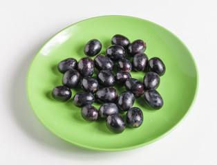 Black grapes on a plate.