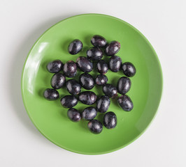 Black grapes on a plate.