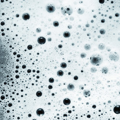 Shampoo or detergent in water. Soap sud. Foam with bubbles. Flat lay.