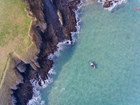 Aerial view of a boat in the Bay at Stackpole Quay, Pembrokeshire, South Wales
