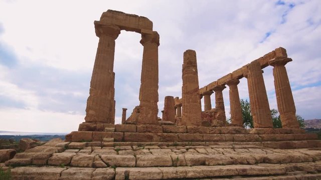 Panning view of greek temple of Juno in the valley of temples in Sicily at sunset