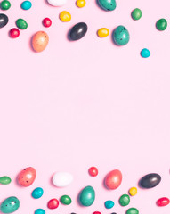 Easter colorful eggs flat lay on white background. Top view, copyspace for text.