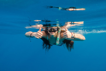 Girl in swimming mask dive in Red sea