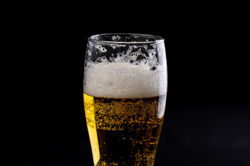 A glass of beer on a black background large - 251828249