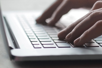 close up.hand of a businessman pressing button on laptop keyboard