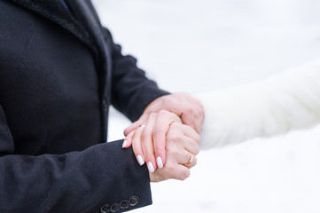 Groom and bride hands with rings. Groom and bride hand to hand