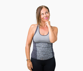 Beautiful middle age woman wearing sport clothes over isolated background with hand on chin thinking about question, pensive expression. Smiling with thoughtful face. Doubt concept.