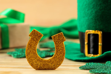 St.Patrick 's Day. celebration. Green leprechaun hat, horseshoe and clover leaves on a natural...