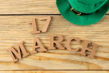 St.Patrick 's Day. celebration. green leprechaun hat and text March 17 on a natural wooden...