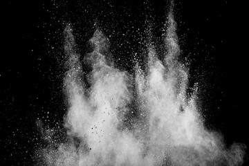 White powder explosion isolated on black background. White dust particles splash.Color Holi...